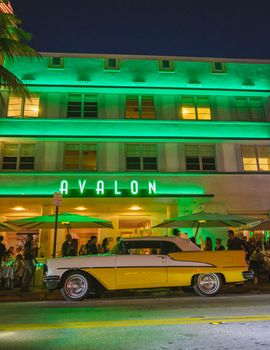 Miami Beach April 2019, colorful Art Deco District at night. Miami Beach Ocean Drive hotels and restaurants at sunset. City skyline with palm trees at night. Art deco nightlife on South beach