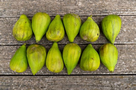 Fresh figs. Ripe figs on a wooden background. Bulk figs close-up.