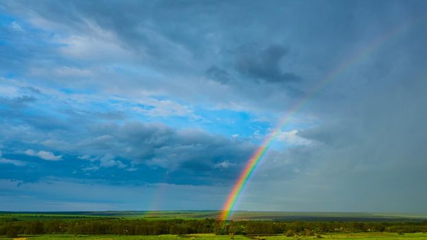 Rainbow over Rural Landscape after Thunderstorm