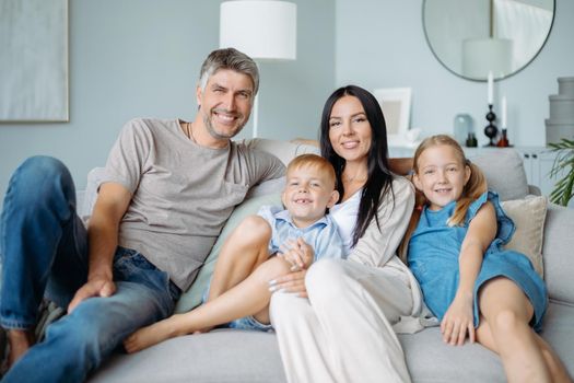 portrait of a happy family with children sitting on the sofa. close-up