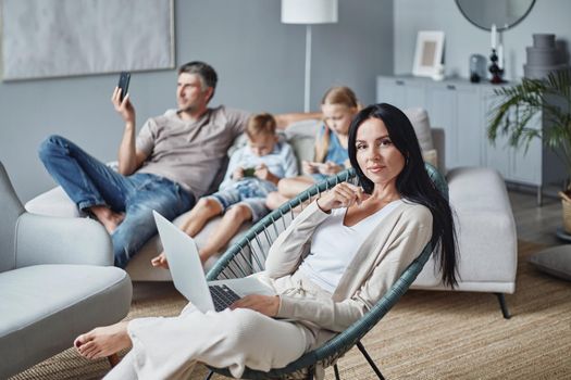 young woman and her family spend their free time with their devices. concept of family pastime.