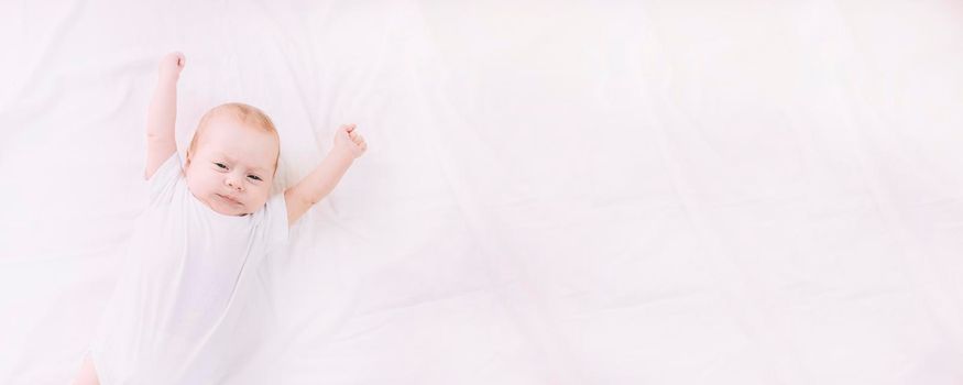 The baby stretches after sleeping Lifestyle . A happy child. Children's article. Copy Space