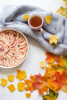Apple pie layout and autumn leaves top view . An article about autumn. An article about baking. Homemade cakes. Autumn picture