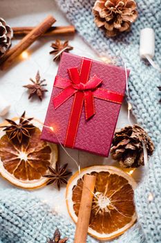 A New Year's gift and a garland with oranges . Christmas and New Year gifts. Holiday. Holiday decorations. Article about the choice of gifts for the holiday