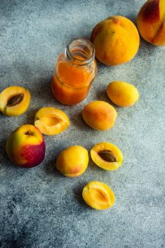 Ripe apricot and pears and the bottle with juice