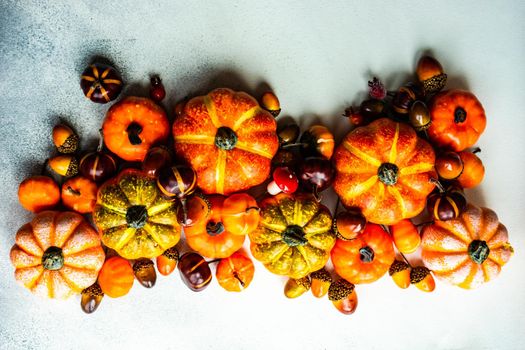 Autumnal frame concept with pumpkins on concrete background