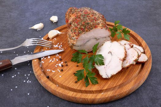 Baked meat on cutting board isolated on black surface