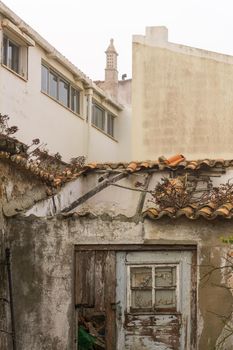 Old abandoned house with a collapsed tile roof in a European city