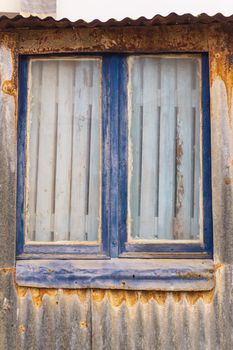 Blocked window of an old abandoned building close up