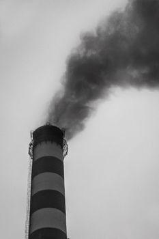 Pollution of the environment, air and ecology are global problems. Toxic smoke from the dirty chimney of an industrial plant is released into the atmosphere.