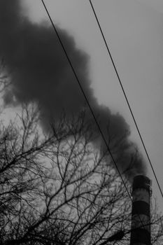 Pollution of the environment, air and ecology are global problems. Toxic smoke from the dirty chimney of an industrial plant is released into the atmosphere.