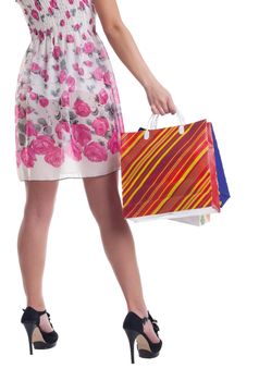 Tall woman legs with stiped shopping bags isolated