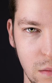 half face young man portrait in dark