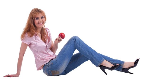 tall Senior woman in jeans sit with apple isolated