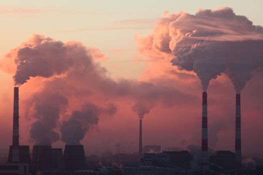 Tube with orange smoke on winter sunset