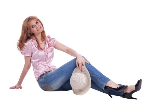 Portrait of mature woman smiling in jeans with straw hat isolated