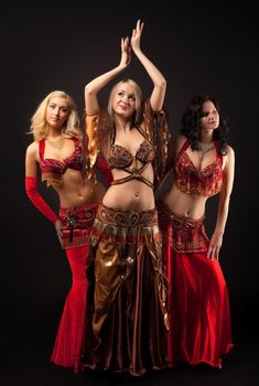 Three beauty young girls dance in arabian costume