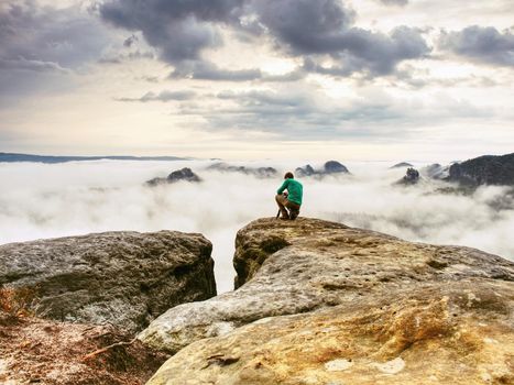 Photographer looks into fall landscape through camera viewfinder. Man prepare camera to takes impressive photos of misty fall mountains.