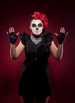 Young woman wearing with roses dressed up for All Souls Day smile snd show hands