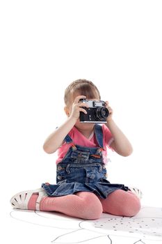 Girl sit with old-style film photo camera isolated