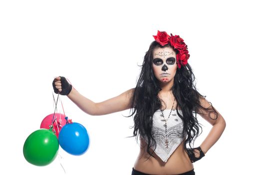 disappointed woman in day of the dead mask with ballons dressed up for All Souls Day