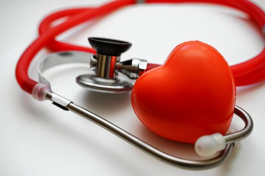 Stethoscope and red heart on white background, heart health, health insurance concept.