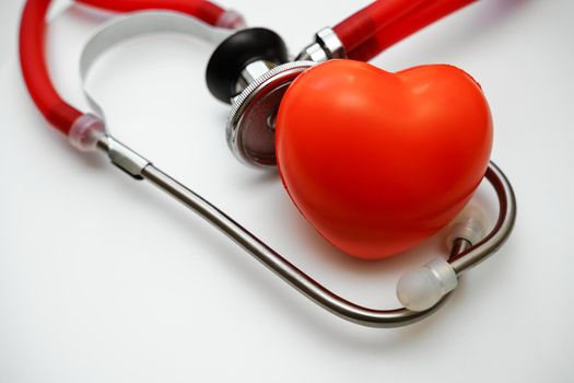 Stethoscope and red heart on white background, heart health, health insurance concept.