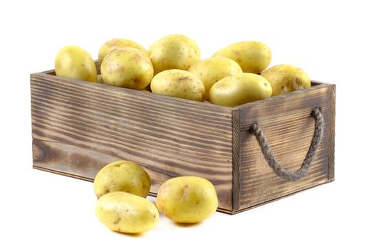 Fresh potatoes in a wooden box isolated on white background with clipping path.