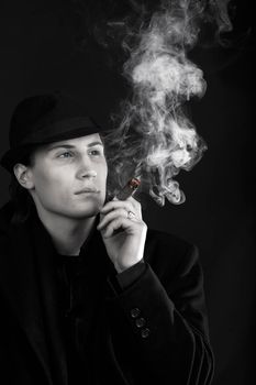 Man in black hat smoke cigar