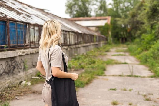 Girl is holding black cotton eco tote bag, design mockup.