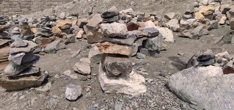 Stack of stones on top of the mountain. Pile of rocks stone and mountains. Balanced stone pyramid or Stacked stone or mountain stones tower. Stones arranged for meditation. Represent spirit of Zen.