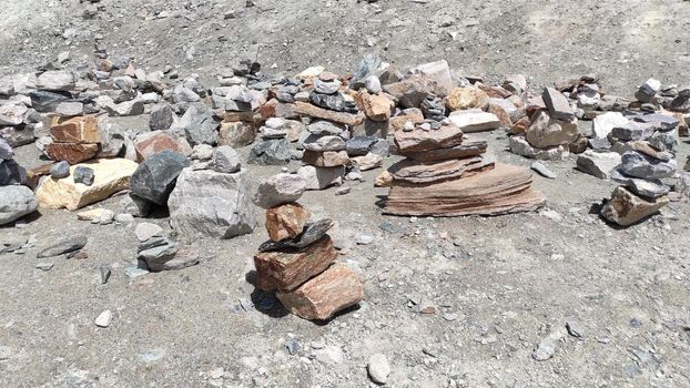 Stack of stones on top of the mountain. Pile of rocks stone and mountains. Balanced stone pyramid or Stacked stone or mountain stones tower. Stones arranged for meditation. Represent spirit of Zen.