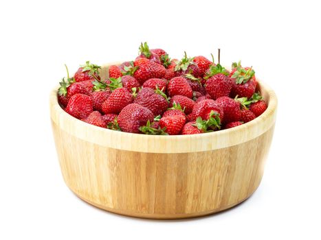 Strawberries in a wooden plate on a white background.Close-up.