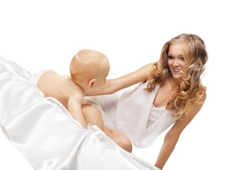 Beauty blond mother look on playful son in bed