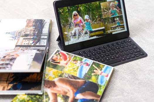 photobook album and tablet on the table.