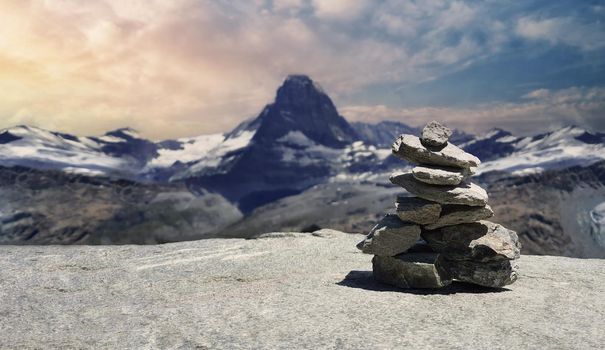 Stack of stones on top of the mountain. Pile of rocks stone and mountains. Balanced stone pyramid or Stacked stone or mountain stones tower. Stones arranged for meditation. Represent spirit of Zen.