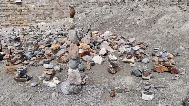 Stack of stones on top of the mountain. Pile of rocks stone and mountains. Balanced stone pyramid or Stacked stone or mountain stones tower. Stones arranged for meditation. Represent spirit of Zen.