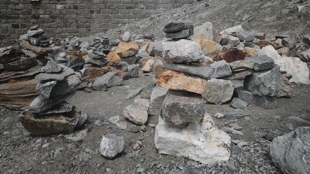 Stack of stones on top of the mountain. Pile of rocks stone and mountains. Balanced stone pyramid or Stacked stone or mountain stones tower. Stones arranged for meditation. Represent spirit of Zen.