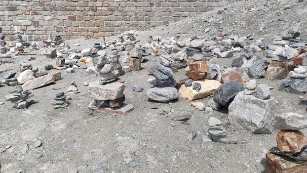 Stack of stones on top of the mountain. Pile of rocks stone and mountains. Balanced stone pyramid or Stacked stone or mountain stones tower. Stones arranged for meditation. Represent spirit of Zen.