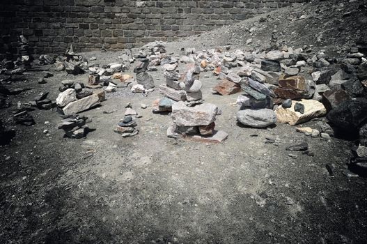 Stack of stones on top of the mountain. Pile of rocks stone and mountains. Balanced stone pyramid or Stacked stone or mountain stones tower. Stones arranged for meditation. Represent spirit of Zen.