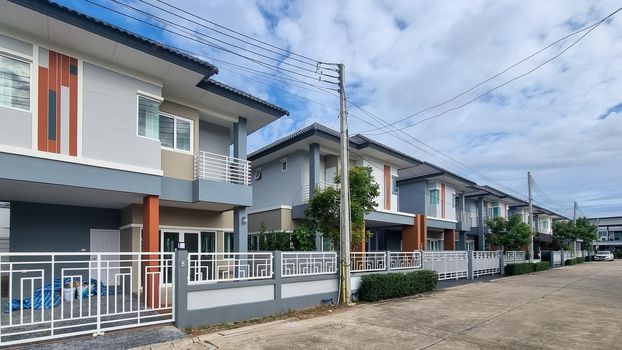 Thai Suburban areas with modern family houses, newly built modern family homes in Thailand, Thai family houses, and apartment houses, newly build streets with modern houses.