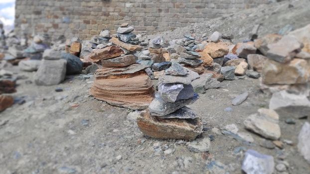 Stack of stones on top of the mountain. Pile of rocks stone and mountains. Balanced stone pyramid or Stacked stone or mountain stones tower. Stones arranged for meditation. Represent spirit of Zen.