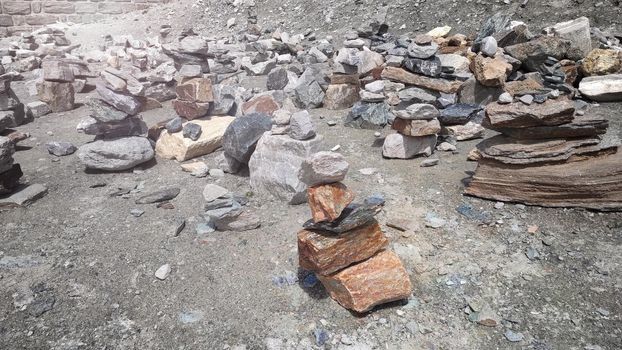 Stack of stones on top of the mountain. Pile of rocks stone and mountains. Balanced stone pyramid or Stacked stone or mountain stones tower. Stones arranged for meditation. Represent spirit of Zen.