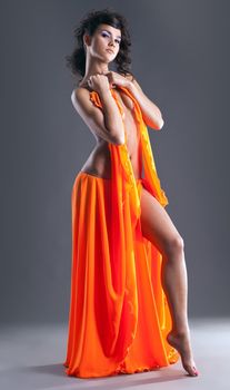 beauty young naked girl dance with orange veil