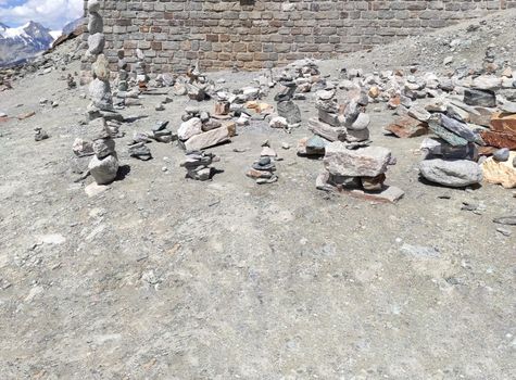 Stack of stones on top of the mountain. Pile of rocks stone and mountains. Balanced stone pyramid or Stacked stone or mountain stones tower. Stones arranged for meditation. Represent spirit of Zen.