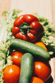 Vertical fresh vegetables red bell pepper tomatoes cucumbers green lettuce. Summer still life. Vegan raw vitamin diet quick dish clean eating organic food.