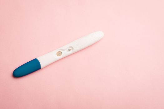 Pregnancy test on a pink background . Positive test. Pregnancy copy space. Motherhood