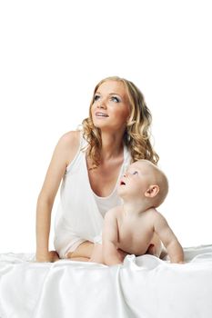 Attractive woman with cute baby look at light in bed isolated