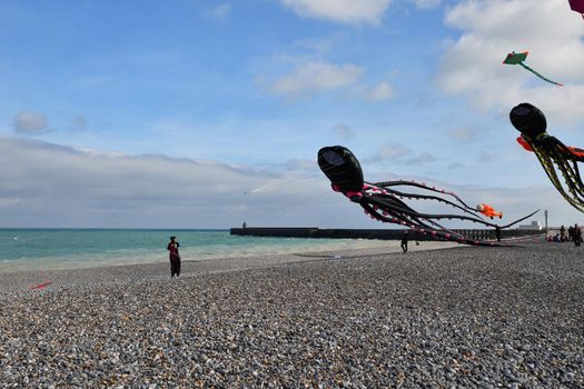 DIEPPE, FRANCE - SEPTEMBER 11, 2018: Kite festival. Octopus kites in the sky in the Atlantic ocean