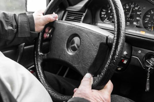 Hands of the driver of the vehicle at the wheel of the car. Driving a auto car.